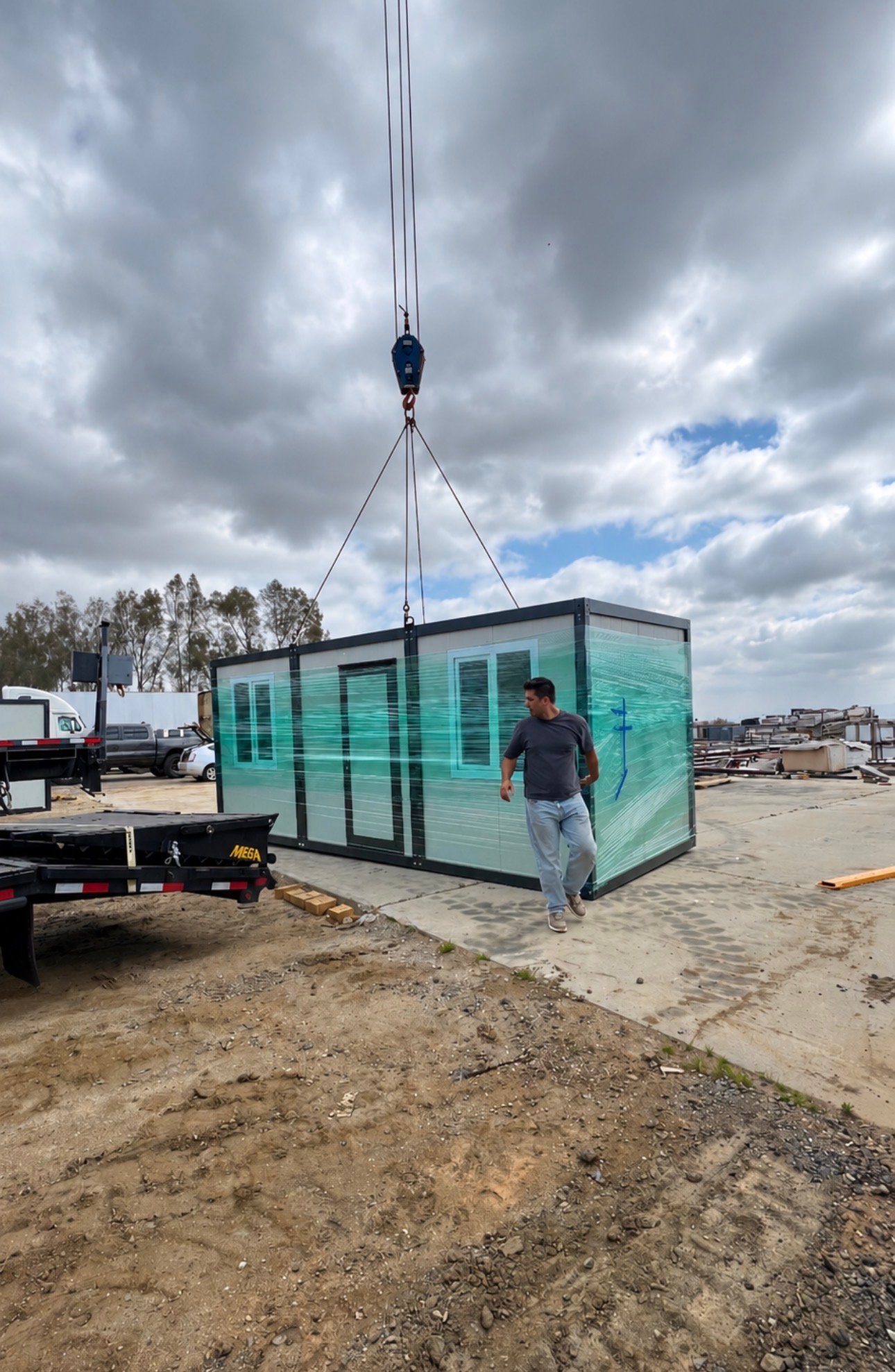 Crane unloading a wrapped EROUnits office