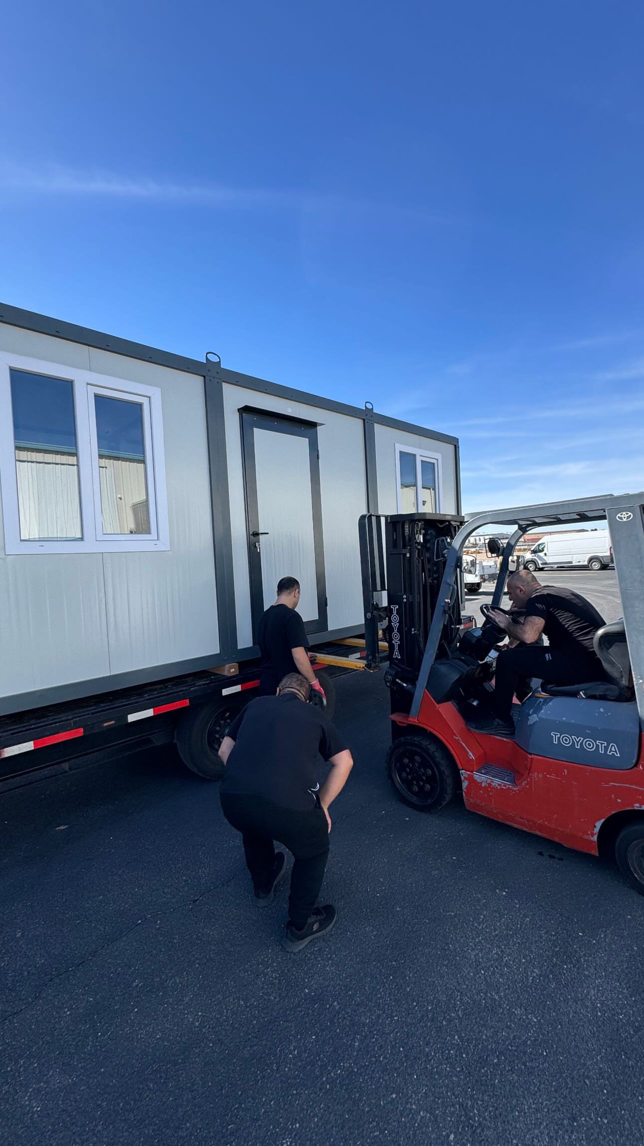Forklift loading an EROUnits office for delivery