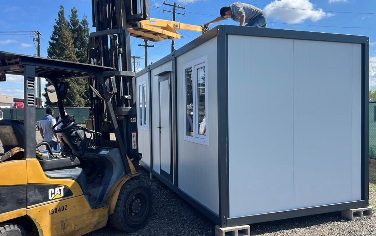 Forklift positioning a completed EROUnits office