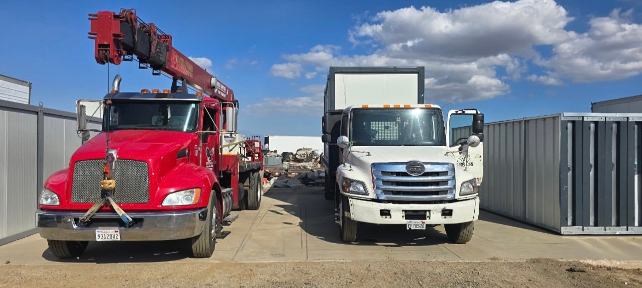 Delivery trucks and EROUnits offices in a project yard